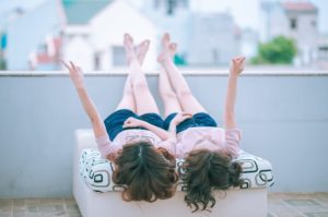 girls lying down on couch on balcony